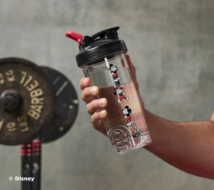 pro-series-k2 Mickey_Mouse_Protein_Shaker_Bottle_Being_Held_In_the_Gym.jpg